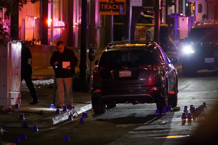 Investigators search for evidence in the area of a mass shooting In Sacramento, Calif. April 3, 2022. (AP Photo/Rich Pedroncelli)