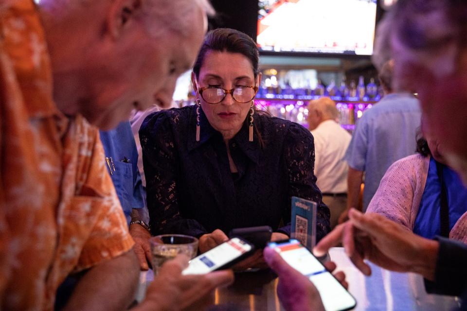 Nueces County Judge Barbara Canales looks at polling numbers during her election night party at Little Woodrow's on Nov. 8, 2022, in Corpus Christi, Texas.