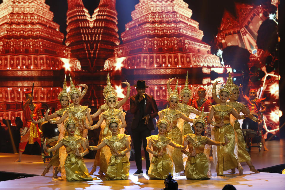 Ne-Yo, al centro, durante su presentación junto a bailarines tailandeses tradicionales en la 67 ma edición de Miss Universo en Bangkok, Tailandia, el 17 de diciembre de 2018. (Foto AP/Gemunu Amarasinghe)