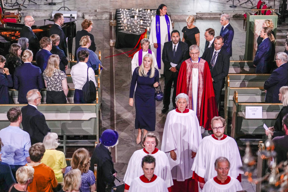 Norway's Crown Princess Mette-Marit, center, and Rev. Olav Fykse Tveit, center right, leave after a service in Oslo Cathedral, Oslo, Sunday June 26, 2022, after an attack in Oslo on Saturday. A gunman opened fire in Oslo’s nightlife district early Saturday, killing two people and leaving more than 20 wounded in what the Norwegian security service called an "Islamist terror act" during the capital’s annual LGBTQ Pride festival. (Javad Parsa/NTB via AP)