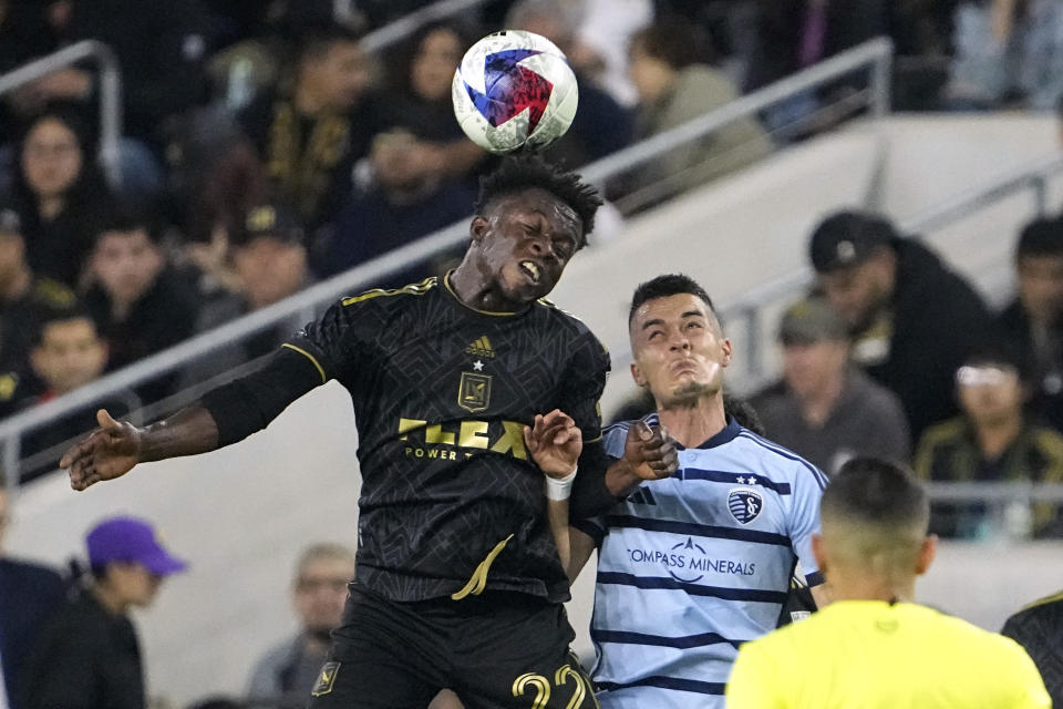 Los Angeles FC forward Kwadwo Opoku, left, and Sporting Kansas City midfielder Erik Thommy try to head the ball during the first half of a Major League Soccer match Wednesday, May 17, 2023, in Los Angeles. (AP Photo/Mark J. Terrill)