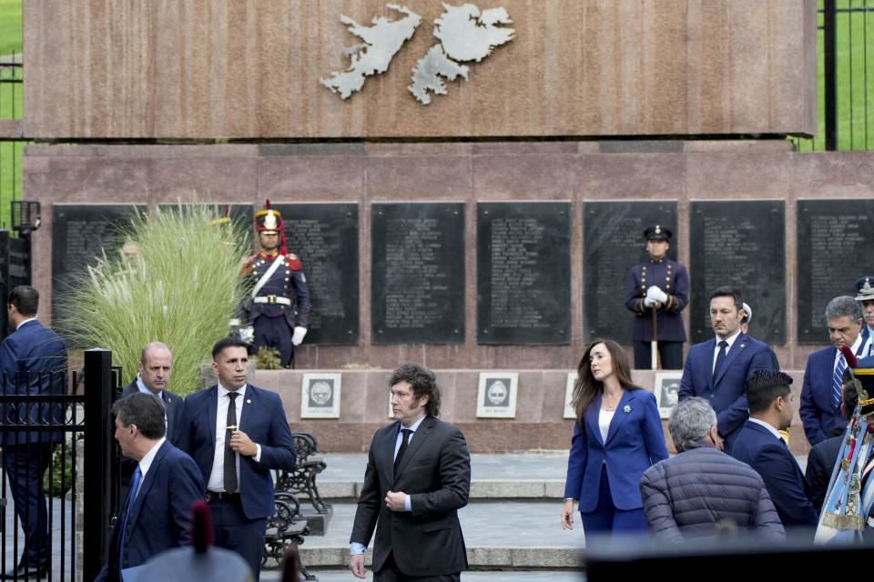 Argentine President Javier Milei, center, visits a war memorial at the official ceremony commemorating the 42nd anniversary of the conflict between Argentina and Great Britain over the Falkland Islands or Malvinas Islands in Buenos Aires, Argentina, Tuesday, April 2, 2024. (AP Photo/Natacha Pisarenko)