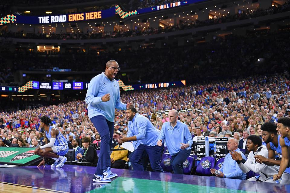 North Carolina Tar Heels head coach Hubert Davis and the bench react after a play against the Kansas Jayhawks during the first half during the 2022 NCAA men's basketball tournament Final Four championship game at Caesars Superdome. 