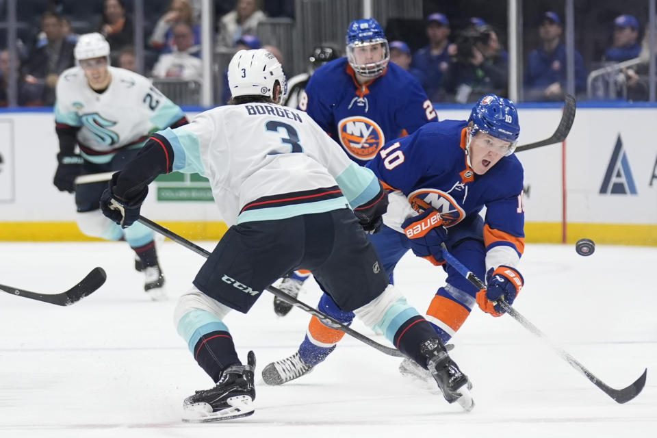 New York Islanders' Simon Holmstrom, right, brings the puck up the ice during the second period of an NHL hockey game against the Seattle Kraken, Tuesday, Feb. 13, 2024, in Elmont, N.Y. (AP Photo/Seth Wenig)