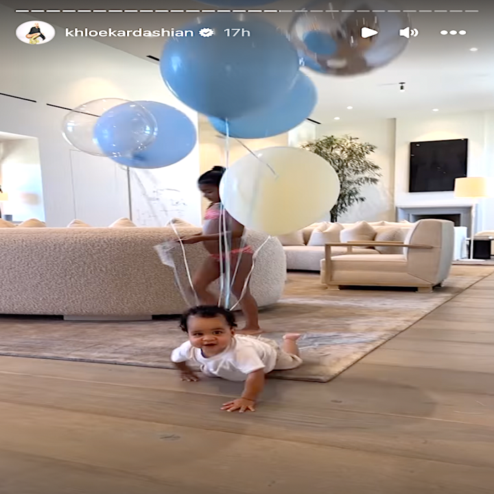 tatum crawling with balloons attached to him
