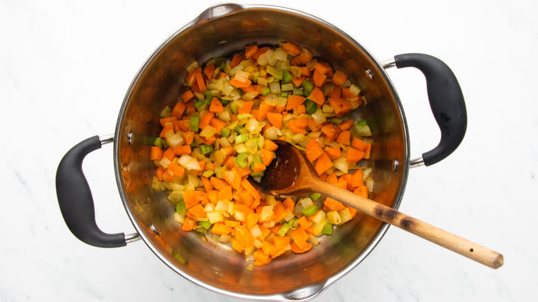 vegetables sauteeing in soup pot