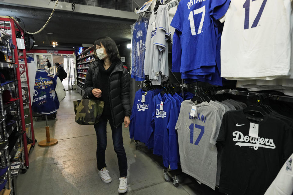 A customer shops for goods related to Shohei Ohtani of the Los Angeles Dodgers at SELECTION, a sporting goods store in Shinjuku district of Tokyo, Thursday, Feb. 29, 2024. (AP Photo/Hiro Komae)