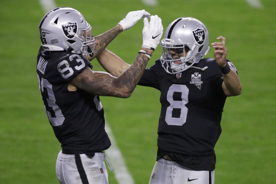 Las Vegas Raiders quarterback Marcus Mariota (8) celebrates after tight end Darren Waller (83) scored a touchdown against the Los Angeles Chargers during the first half of an NFL football game, Thursday, Dec. 17, 2020, in Las Vegas. (AP Photo/Isaac Brekken)