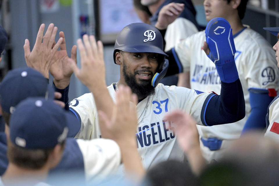 Los Angeles Dodgers' Teoscar Hernandez is greeted in the dugout after scoring in the first inning against the Pittsburgh Pirates during a baseball game Saturday, Aug. 10, 2024, in Los Angeles. (AP Photo/Jayne-Kamin-Oncea)