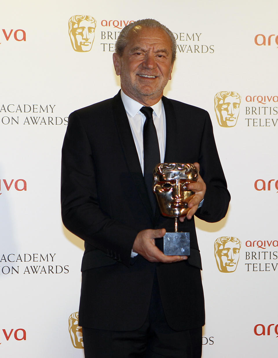 British businessman Alan Sugar holds the Reality and Factual Award for Young Apprentice at  the British Academy Television Awards in London, Sunday, May 27, 2012. (AP Photo/Kirsty Wigglesworth)