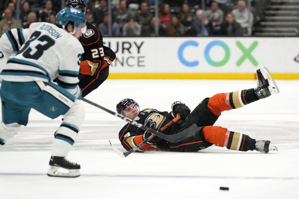 Anaheim Ducks right wing Jakob Silfverberg, right, falls as San Jose Sharks defenseman Calen Addison takes the puck during the first period of an NHL hockey game Wednesday, Jan. 31, 2024, in Anaheim, Calif. (AP Photo/Mark J. Terrill)