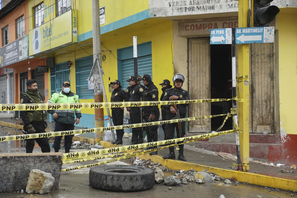 Police block a road that leads to government offices the day after protests that called for the closure of Congress, the resignation of the new President Dina Boluarte and for general elections in Andahuaylas, Peru, Tuesday, Dec. 13, 2022. Peru's President Pedro Castillo was detained on Dec. 7 after he was ousted by lawmakers when he sought to dissolve Congress ahead of an impeachment vote. (AP Photo/Franklin Briceno)