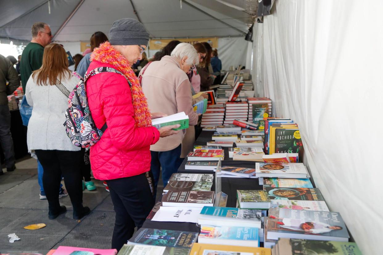 Patrons browse the selection of books available to purchase inside the Ex Libris bookstore tent on Saturday February 18, 2023 during the annual Savannah Book Festival in Telfair Square.