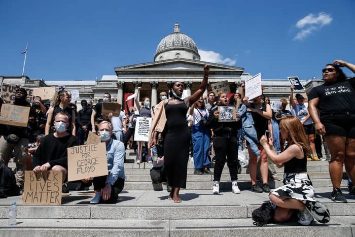 People with signs gather for a Black Lives Matter protest in London, England