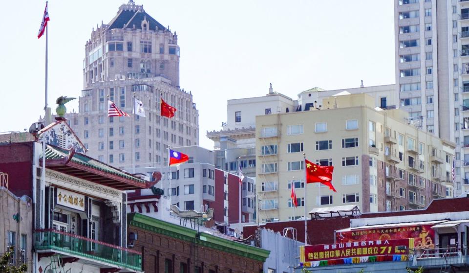 Various flags hang in San Francisco's Chinatown on Sept. 28, 2020. The area has been a magnet for Chinese immigrants since the 19th-century Gold Rush and is home to densely packed single-room-occupancy housing that many fear will accelerate COVID-19 outbreaks.