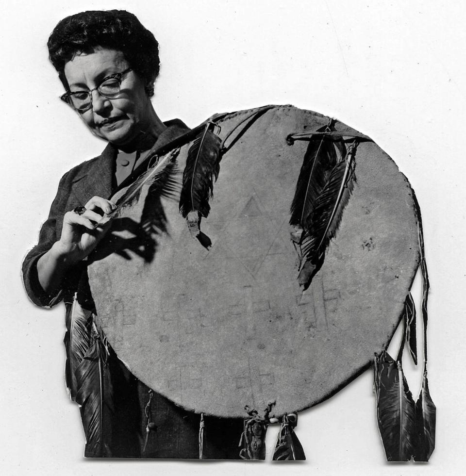 Louise Fluke, who designed the state flag, holds the Osage shield that was the inspiration behind the design for the Oklahoma state flag.