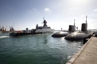 A Russian navy missile ship 'Veliky Ustyug' sails off from the Russian naval facility in Tartus, Syria, on patrol in eastern Mediterranean, Thursday, Sept. 26, 2019. Two Russian diesel-electric submarines of the project 636.3 Varshavyanka' are seen on the right. Russia has a naval base in Tartus, the only such facility it has outside the former Soviet Union. (AP Photo/Alexander Zemlianichenko)