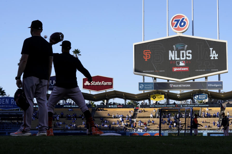 San Francisco Giants players warm up at Dodger Stadium before Game 4 of the baseball team's National League Division Series against the Los Angeles Dodgers, Tuesday, Oct. 12, 2021, in Los Angeles. (AP Photo/Ashley Landis)