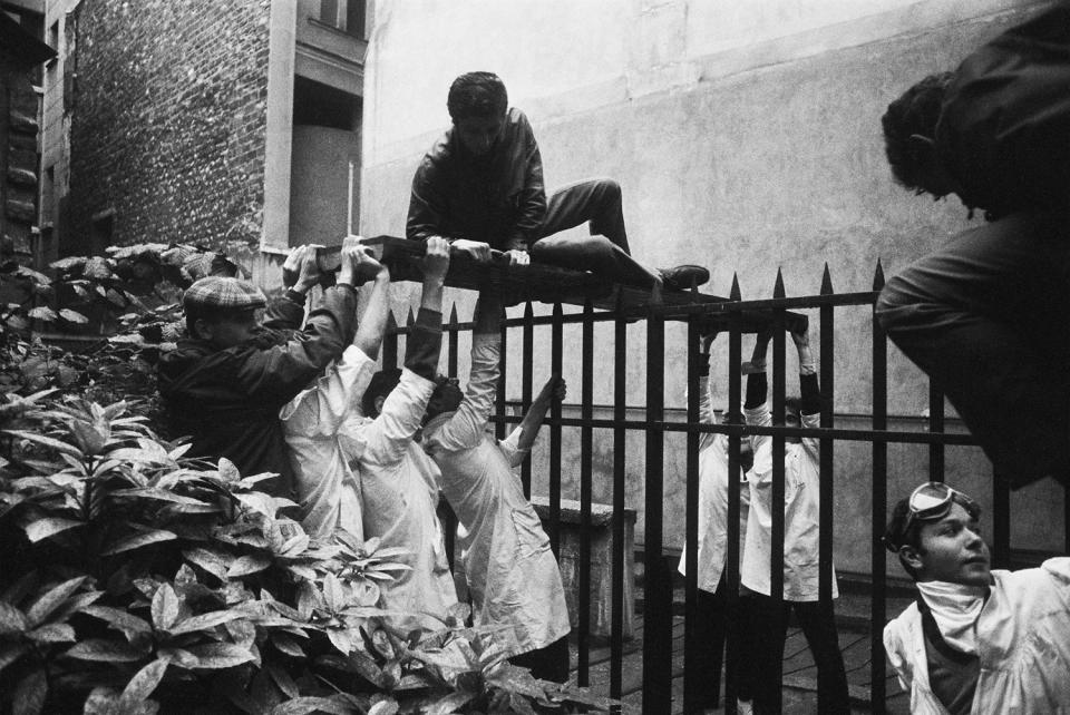 <p>A student, among the many injured during confrontations with police, is given assistance in Paris on May 6, 1968. Striking students erected the first street barricades at the Place Maubert, and then 30,000 people marched from the Place Denfert-Rochereau until they were stopped by CRS riot police. (Photo: Gökşin Sipahioğlu/SIPA) </p>