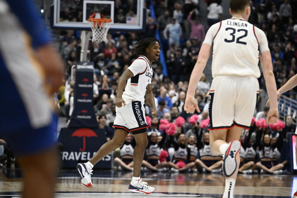 UConn guard Tristen Newton, center, celebrates in the first half of an NCAA college basketball game against Xavier, Sunday, Jan. 28, 2024, in Hartford, Conn. (AP Photo/Jessica Hill)