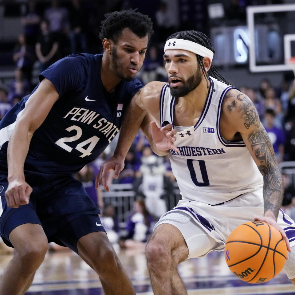 Northwestern guard Boo Buie, right, drives against Penn State forward Zach Hicks, left, during the second half of an NCAA college basketball game in Evanston, Ill., Sunday, Feb. 11, 2024. (AP Photo/Nam Y. Huh)