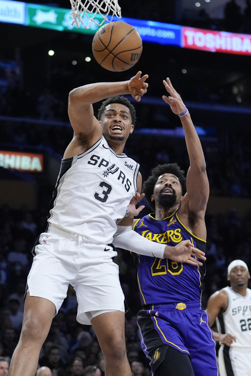 San Antonio Spurs forward Keldon Johnson (3) works for a rebound against Los Angeles Lakers guard Spencer Dinwiddie during the first half of an NBA basketball game Friday, Feb. 23, 2024, in Los Angeles. (AP Photo/Marcio Jose Sanchez)
