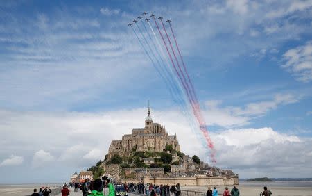 Cycling - The Tour de France cycling race - The 188-km (117 miles) 1st stage from Mont Saint-Michel to Utah Beach Sainte-Marie-du-Mont, France - 02/07/2016 - Alphajet planes from the Patrouille de France (France's Patrol) fly over the Mont Saint-Michel. REUTERS/Juan Medina