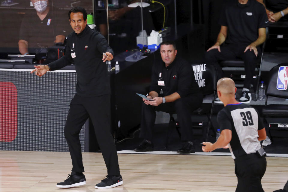 Miami Heat head coach Erik Spoelstra talks with referee Tyler Ford (39) during the first half of an NBA basketball game against the Indiana Pacers Friday, Aug. 14, 2020, in Lake Buena Vista, Fla. (Kim Klement/Pool Photo via AP)