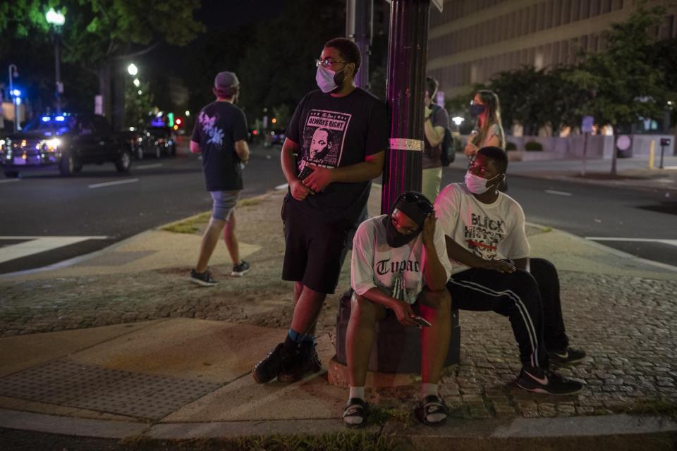 From left, Ramon Obey II, Heather Johnson and her 13-year-old son, Elyjah, join protests outside the White House at the end of the Republic National Convention on Aug. 27, 2020, the night before attending the "Get Your Knee Off Our Necks" March in Washington D.C. on the anniversary of the 1963 March on Washington.