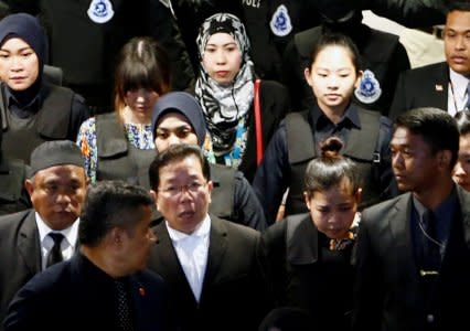 FILE PHOTO: Indonesian Siti Aisyah and Vietnamese Doan Thi Huong, who are on trial for the killing of Kim Jong Nam, the estranged half-brother of North Korea's leader, are escorted as they revisit the Kuala Lumpur International Airport 2 in Sepang, Malaysia October 24, 2017. REUTERS/Lai Seng Sin