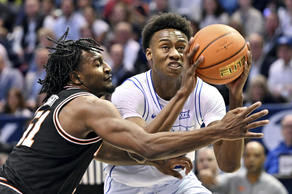 Oklahoma State Cowboys guard John-Michael Wright (51) defends BYU guard Jaxson Robinson as he drives to the basket during an NCAA college basketball game in Provo, Utah, Saturday, March 9, 2024. (Scott G Winterton/The Deseret News via AP)