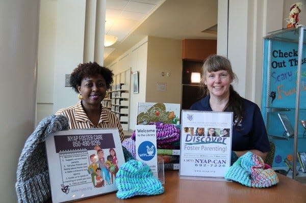 West Florida Public Libraries donates winter hats to local foster children.