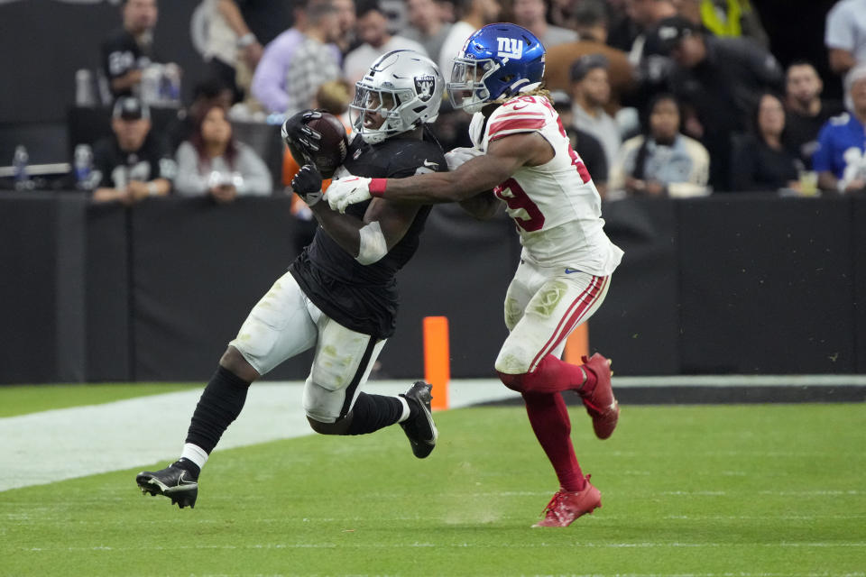 New York Giants safety Xavier McKinney (29) hits Las Vegas Raiders running back Josh Jacobs during the second half of an NFL football game, Sunday, Nov. 5, 2023, in Las Vegas. (AP Photo/Rick Scuteri)