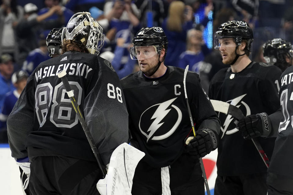 Tampa Bay Lightning goaltender Andrei Vasilevskiy (88) celebrates with center Steven Stamkos (91) after the Lightning defeated the Dallas Stars during an NHL hockey game Saturday, Jan. 15, 2022, in Tampa, Fla. (AP Photo/Chris O'Meara)