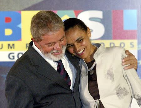 Brazil's then-President Luiz Inacio Lula da Silva (L) embraces his Environment Minister Marina Silva during a ceremony at the Planalto Palace in Brasilia, in this March 2, 2006 file photo. REUTERS/Jamil Bittar/Files