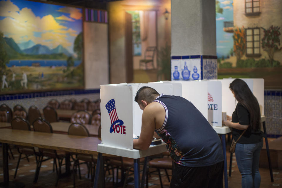 Latinos vote at a polling station in El Gallo Restaurant on Nov. 8, 2016, in the Boyle Heights section of Los Angeles. (Photo: David McNew/Getty Images)