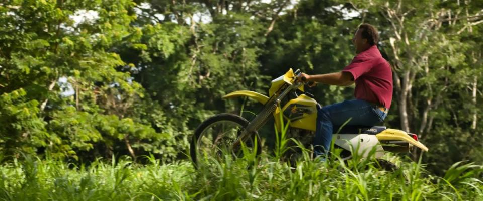 Spanish lookout, Belize - September 2, 2018 Henry Plett riding off road with his Suzuki  Drz250 at Mennonite beach
