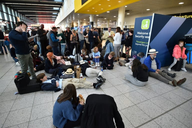 Passengers wait at the North Terminal at London Gatwick Airport,as police frantically searched for the operators of the drones that had forced the suspension of all flights