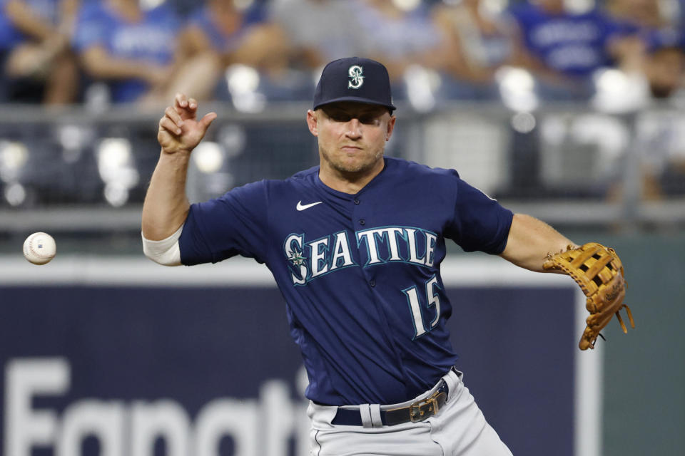 Seattle Mariners third baseman Kyle Seager loses the ball after fielding a grounder from Kansas City Royals' Whit Merrifield during the eighth inning of a baseball game at Kauffman Stadium in Kansas City, Mo., Saturday, Sept. 18, 2021. Seager was charged with an error on the play. (AP Photo/Colin E. Braley)