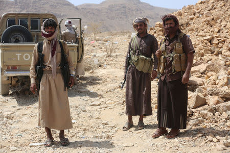 Members of the Popular Resistance militiamen backing Yemen's President Abd-Rabbu Mansour Hadi stand next to a truck as they head to the frontline of fighting against forces of Houthi rebels in Makhdara area of Marib province, Yemen June 28, 2017. Picture taken June 28, 2017. REUTERS/Ali Owidha