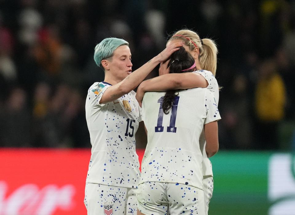 United States forward Megan Rapinoe (15) and midfielder Lindsey Horan (10) console forward Sophia Smith (11) after losing to Sweden in a round of 16 match in the World Cup.