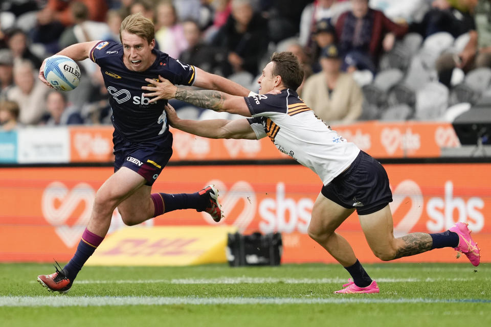 Highlanders Cameron Millar, left, attempts to fend off Brumbies Corey Toole during the Super Rugby Pacific match between the Highlanders and the ACT Brumbies at Forsyth Barr Stadium in Dunedin, New Zealand, Saturday, March 16, 2024. (Michael Thomas/AAP Image via AP)