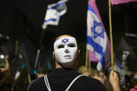 A man wears a mask at a protest outside of Israeli Prime Minister Benjamin Netanyahu's residence in Jerusalem, Saturday, Oct. 24, 2020. Weekly protests have been taking place for the past four months, with crowds calling on Netanyahu to resign over criminal corruption charges and his handling of the coronavirus. (AP Photo/Maya Alleruzzo)