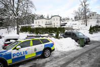 A police car is parked outside a house where the Swedish Security Service allegedly arrested two people on suspicions of espionage in a predawn operation in Stockholm, Tuesday, Nov. 22 2022. The authorities gave few details about the case, but Swedish media cited witnesses who described elite police rappelling from two Black Hawk helicopters to arrest a couple that had allegedly spied for Russia. (Fredrik Sandberg/TT News Agency via AP)