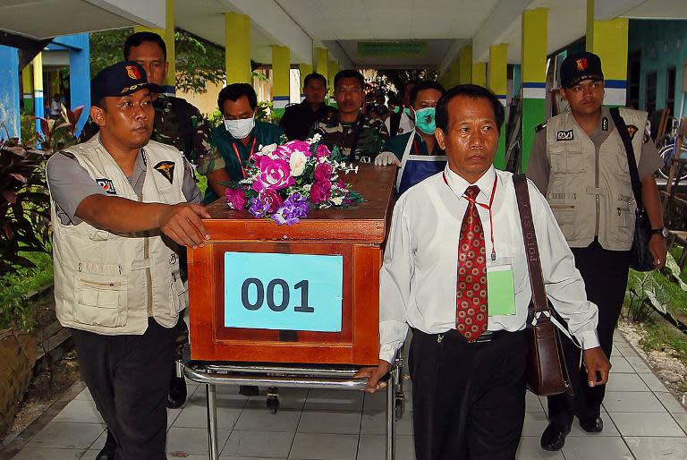 A coffin of a victim of AirAsia flight QZ8501 is transferred from a local hospital in Pangkalan Bun -- the town with the nearest airstrip to the crash site in Central Kalimantan -- on December 31, 2014