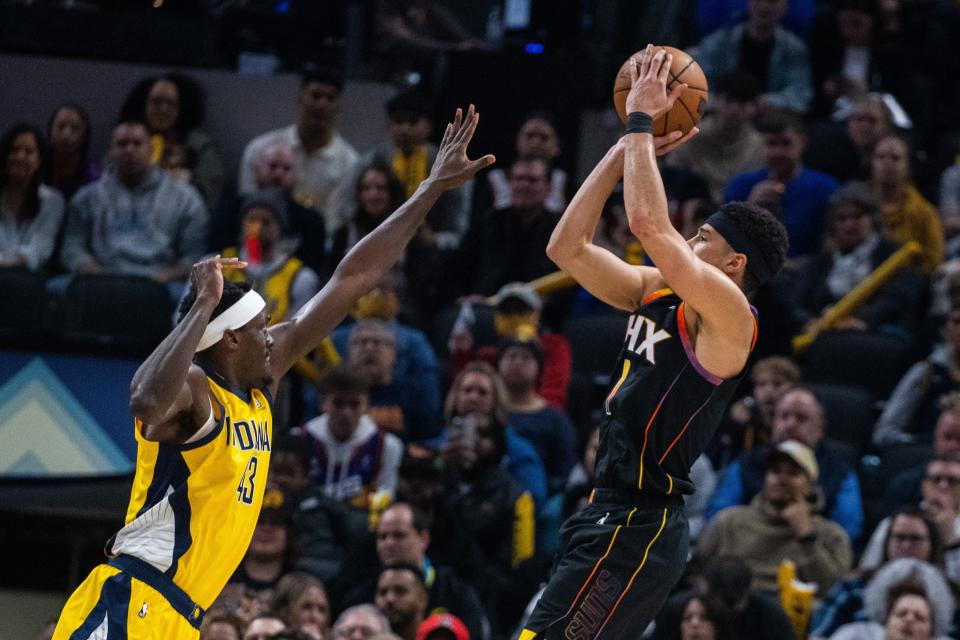 Jan 26, 2024; Indianapolis, Indiana, USA; Phoenix Suns guard Devin Booker (1) shoots the ball while Indiana Pacers forward Pascal Siakam (43) defends in the first half at Gainbridge Fieldhouse.