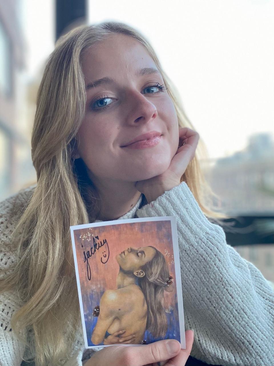 Jackie Evancho -- who, like Joni Mitchell, also paints -- poses with a self-portrait inspired by Mitchell's artistry. (Photo courtesy of the artist)