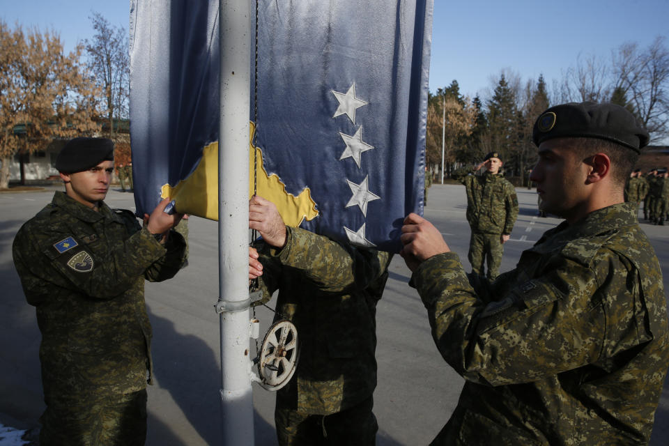 Members of Kosovo's Security Forces are lined up during the flag raising ceremony in this southeastern town of Gjilan, Kosovo on Thursday, Dec. 13, 2018, a day before the parliament votes to transform them into a regular army. Kosovo lawmakers are set to transform the Kosovo Security Force into a regular army, a move that significantly heightened tension with neighboring Serbia which even left open a possibility of an armed intervention in its former province. (AP Photo/Visar Kryeziu)