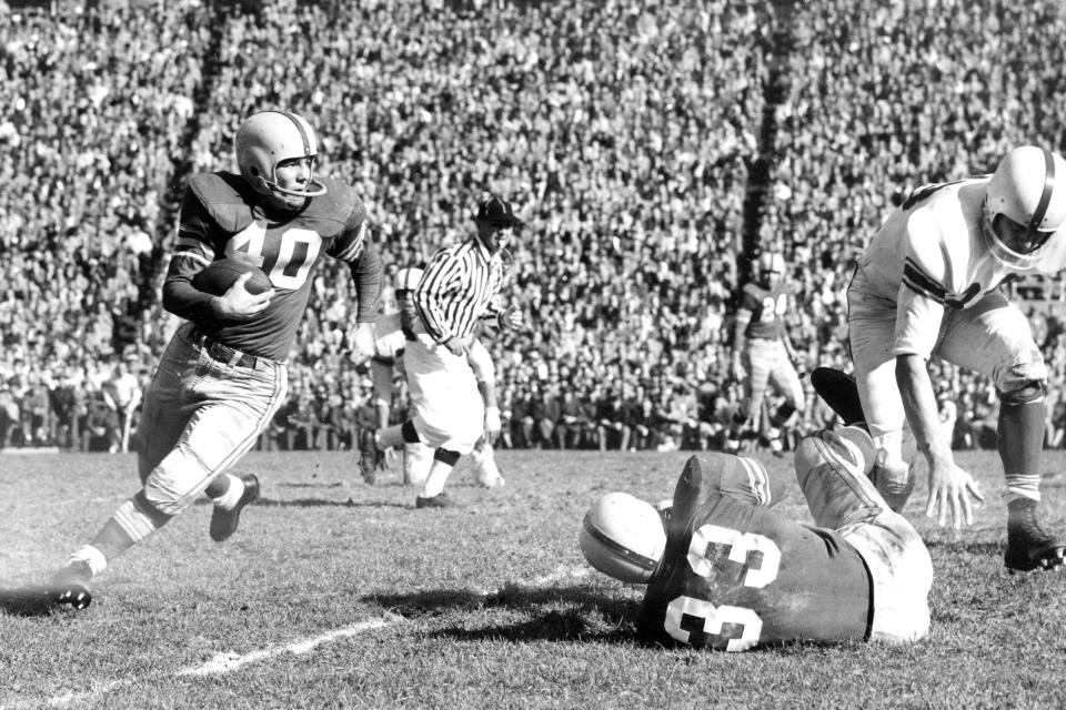 FILE - In this Nov. 1955, file photo, Ohio State halfback Howard "Hopalong" Cassady (40) carries the ball against Indiana during a college football game in Columbus, Ohio. Cassady, a Heisman Trophy winner and former NFL running back, died early Friday, Sept. 20, 2019, in Tampa, Fla., Jerry Emig, the Ohio State associate athletic director said. He was 85. Cassady played both football and baseball at Ohio State in the early 1950s, winning the Heisman Trophy in 1955. He also played 10 seasons in the NFL, mostly with the Detroit, and got the nickname "Hopalong" from local sports writers after the black-hatted Western star of the 1950s. (AP photo)