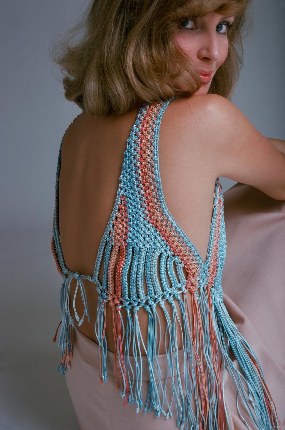 A woman in a crocheted top